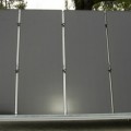 A wall of solar power modules are found in the back parking lot at Stion.