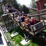 Families take a ride on a rollercoaster at Happy Hollow Zoo.