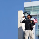 As the rich get richer, Shaun "Cracker" O'Kelly's scaling of a 36-foot wall at San Jose's City Hall has elevated the prominence of the issue locally. (Photo by Felipe Buitrago)