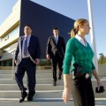 San Jose Police Chief Chris Moore (left), Sgt. Jason Dwyer (middle) and the chief's adjutant, Gina Tibaldi, exit the empty $90 million police substation. (Photo by Felipe Buitrago)