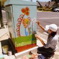 Artist Florence de Bretagne works on a new art box at the junction of Pine Street and Lincoln Street.`