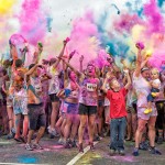 Runners are covered in dust at the Color Me Rad 5k run.