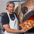 Angelo Womack oversees the new pizza oven at Oak & Rye.