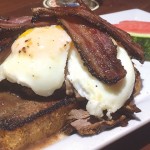 TAKE THE OVER: Over/Under’s menu puts artistry back into pub grub favorites, like this angus brisket with eggs and bacon.