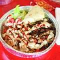 GET SAUCED: The Halal Guys chicken and rice dish is served with their special red and white sauces.
