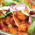 The decadent Chilli Paneer combines sweet and spicy tomato sauce with fried of chunks of cheese.